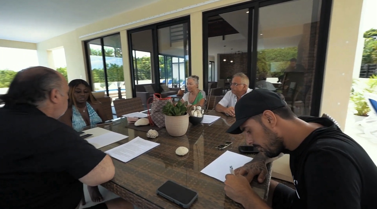 Clients seated with the VOYAĠ team during a property meeting