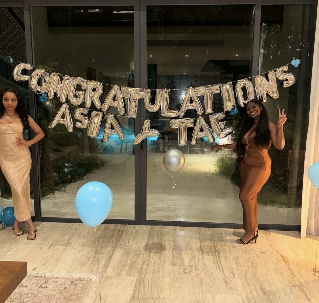 Clients standing together beside a congratulatory sign