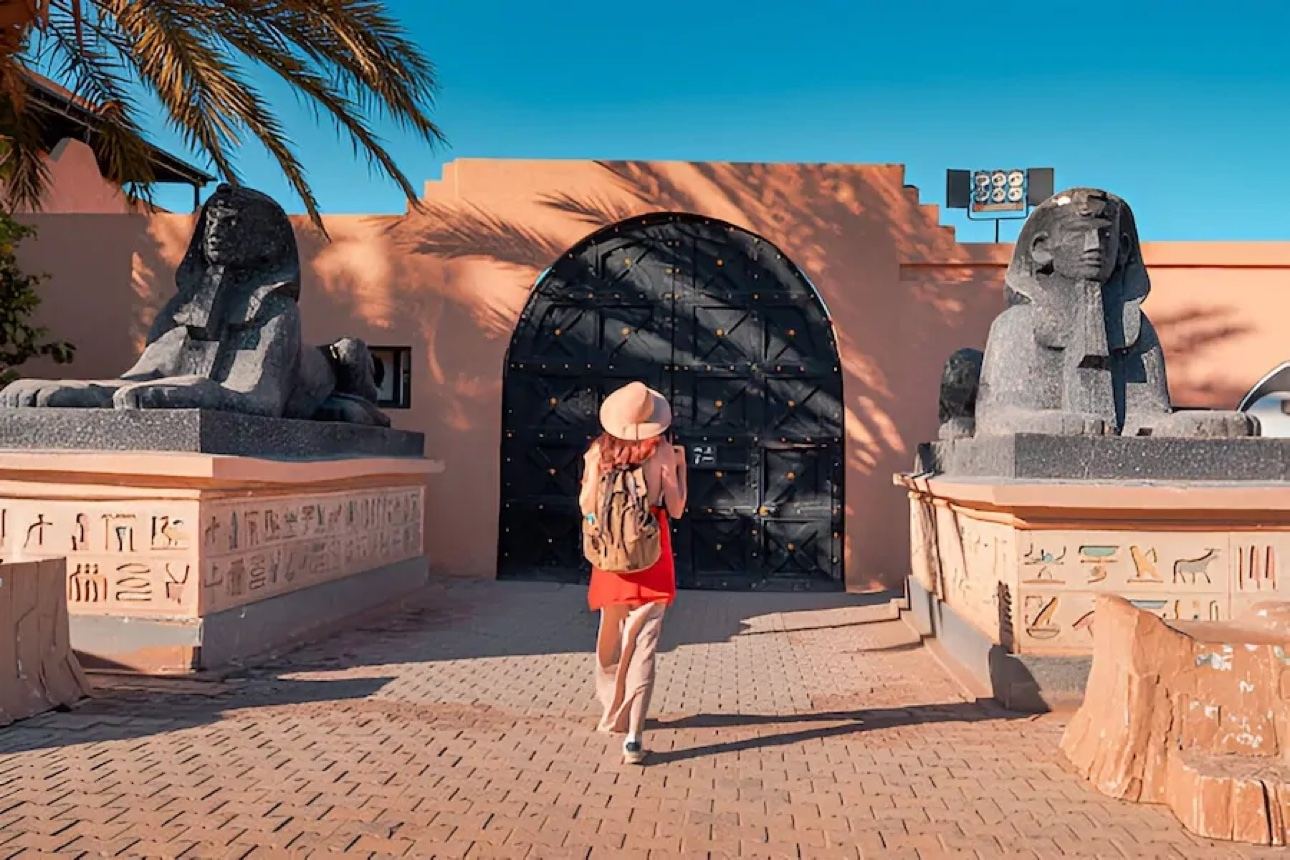 Traveler approaching a monumental arched entrance in Morocco