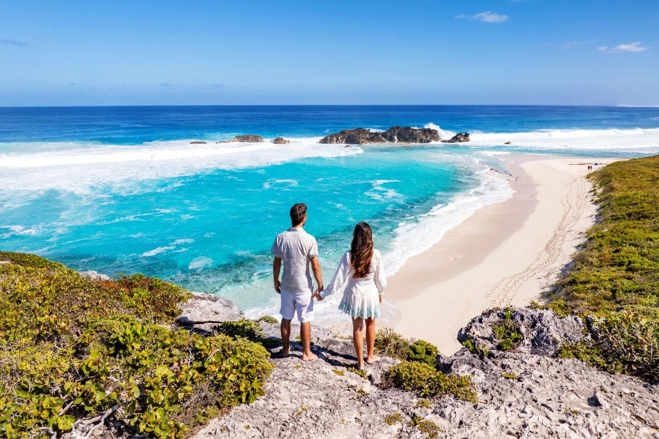 Couple overlooking a turquoise beach in Turks and Caicos