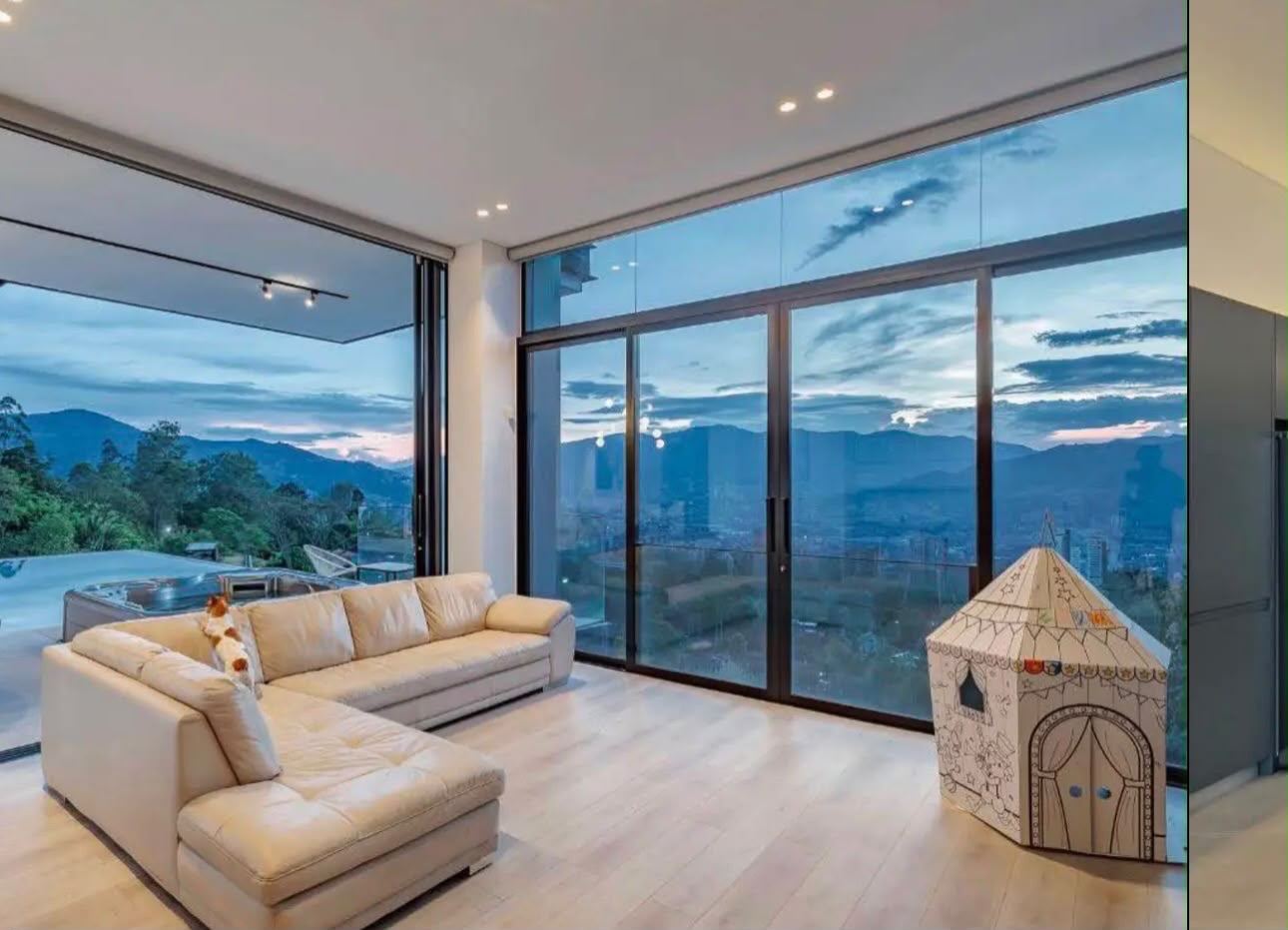 Glass-walled living room with mountain view