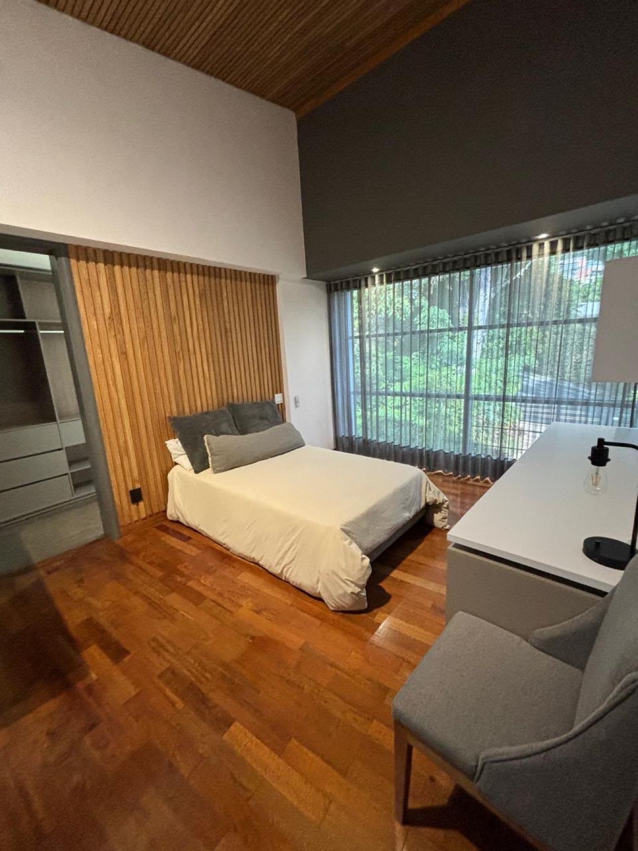 Bright bedroom with wood flooring