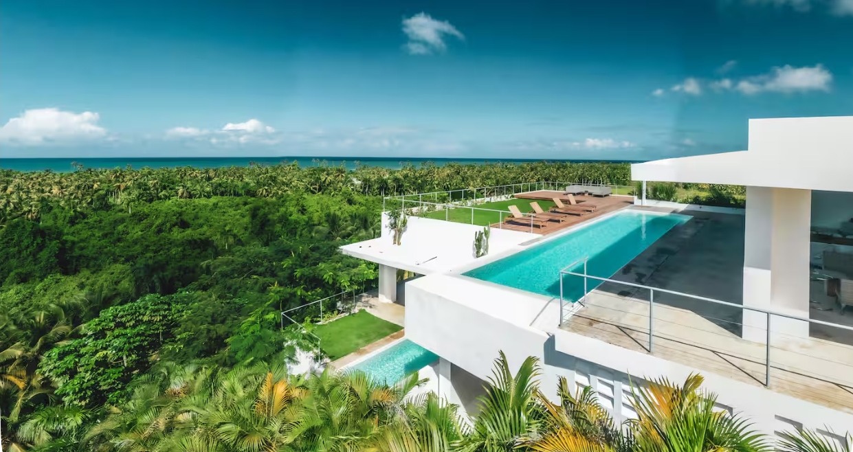 Aerial view of Villa Carlito's two swimming pools and ocean setting above Las Terrenas