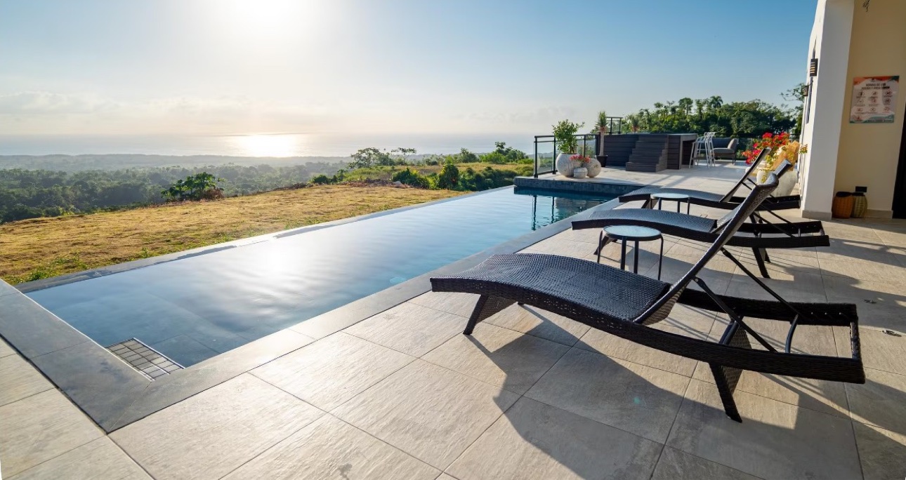 Pool loungers beside the infinity pool overlooking the ocean at the five-bedroom villa in the Dominican Republic