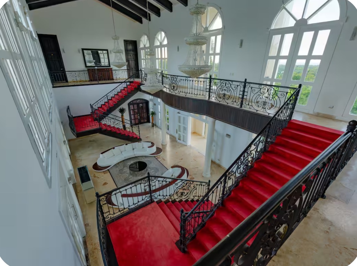 Interior staircase and red billiards table inside the mansion