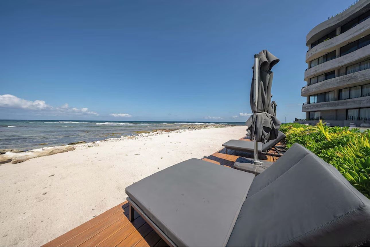 Beachfront lounge chairs overlooking the Caribbean Sea in Tulum