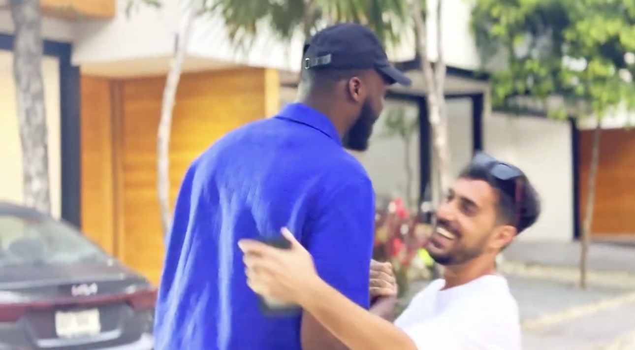 VOYAĠ founder in a blue shirt greeting his property broker outdoors